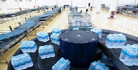 Image of multiple bottled water package on conveyor